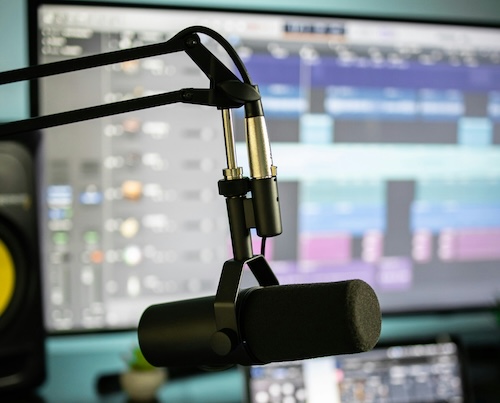 microphone and a computer screen in the background